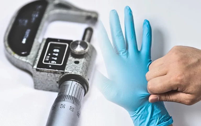 Close-up of a micrometer and a hand putting on a nitrile glove. The micrometer reads 1.776 mm.