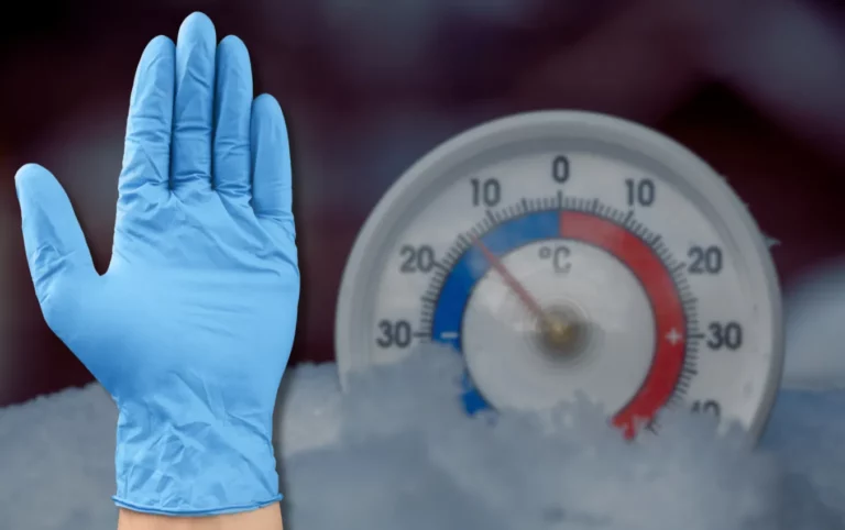 Blue nitrile glove against a cold temperature thermometer.