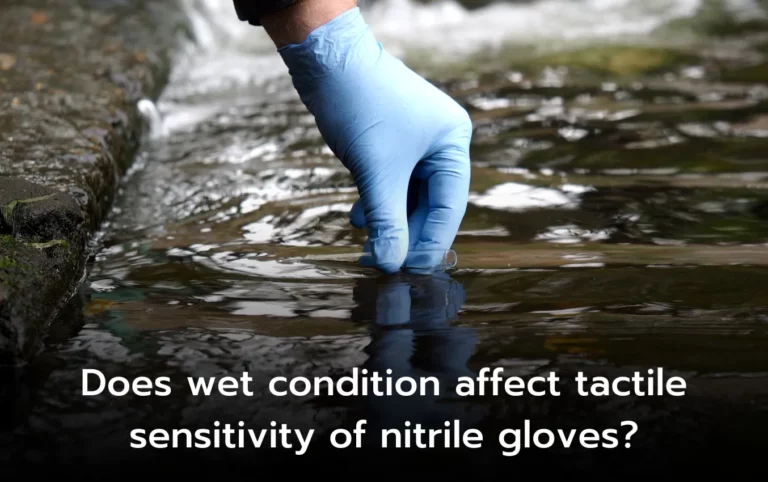 Hand in blue nitrile glove testing water. Does wetness affect tactile sensitivity?